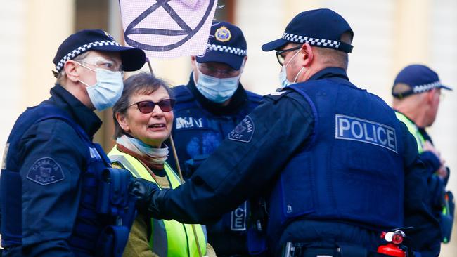 An Extinction Rebellion protester blocking traffic in Launceston's CBD is arrested by police on Thursday July 16, 2020. Picture: PATRICK GEE