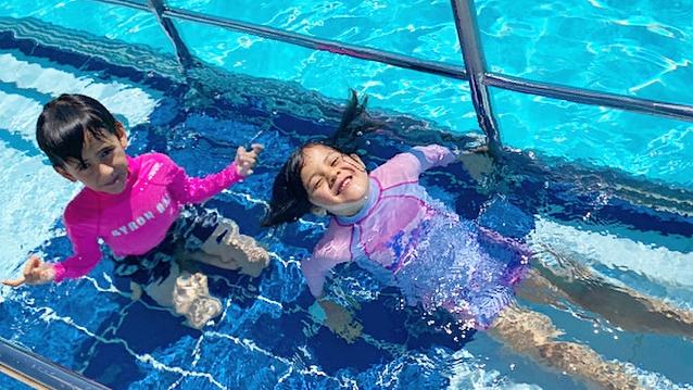 Siblings Santiago and Yindi Cooper enjoying the water at the Ballina Memorial Swimming Pool & Waterslide in October 2020. Photo: Javier Encalada