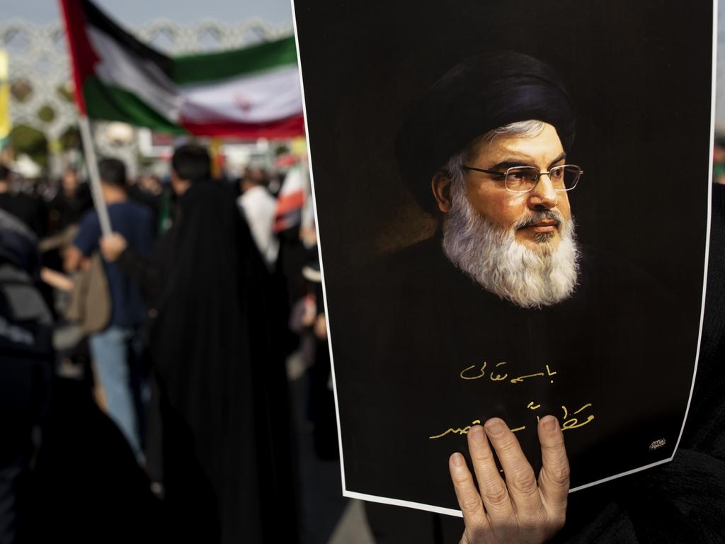 An Iranian demonstrator carries a poster of slain Hezbollah leader Hassan Nasrallah in a rally commemorating him on October 2 in Tehran. Picture: Majid Saeedi/Getty Images