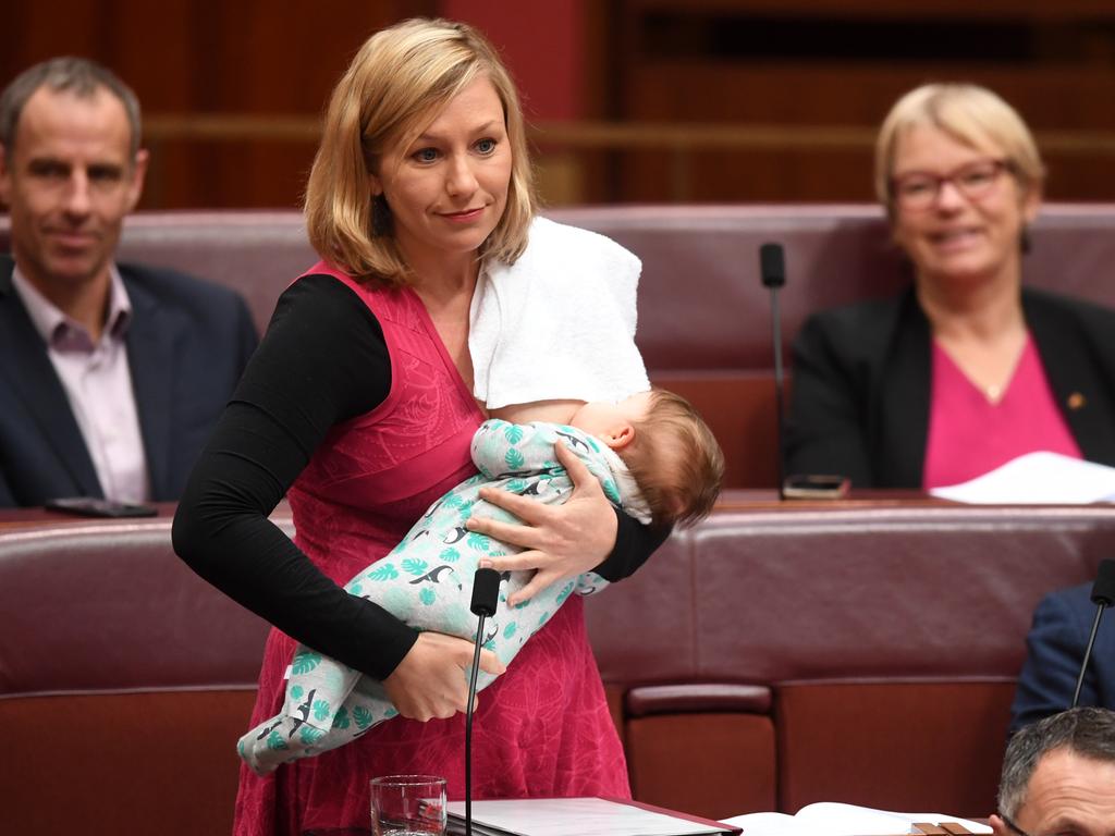 Larissa Waters putting forward a motion on Black Lung disease while breastfeeding her daughter Alia. Picture: AAP Image/Lukas Coch