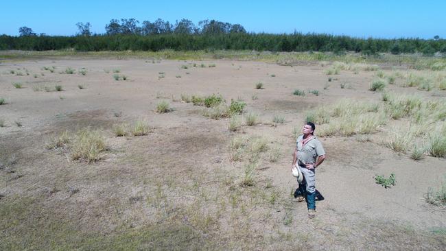 Matt Keys from Habitat Environment Management checks on the effects of the big dry on the water table at Pimpama Wetlands Sanctuary. Picture: Glenn Hampson