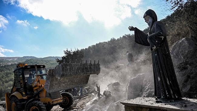 A statue of the 19th-century Maronite Christian St Charbel remains standing in a site of an Israeli air strike on the Christian village of Aito in northern Lebanon. Picture: Joseph Eid