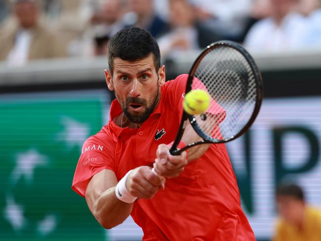 PARIS, FRANCE - MAY 29: Novak Djokovic of Serbia plays a backhand against Corentin Moutet of France during the Men's Singles Second Round match on Day Five of the 2025 French Open at Roland Garros on May 29, 2025 in Paris, France.  (Photo by Clive Brunskill/Getty Images)