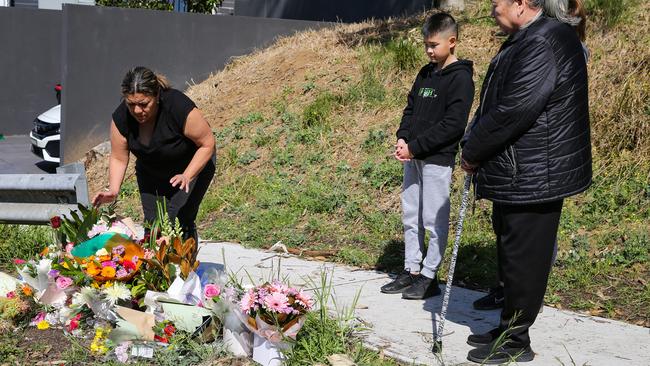 Family and friends lay flowers where the Kauffman siblings were killed.