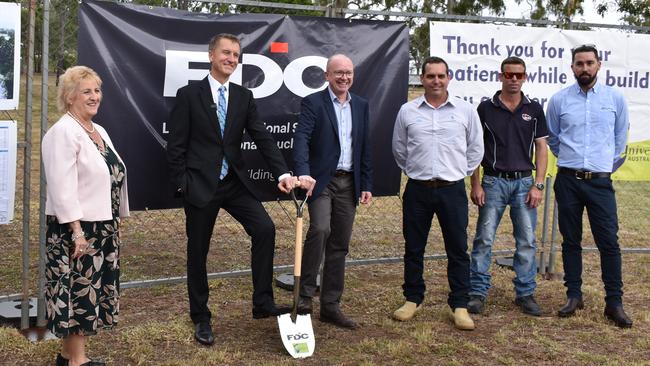 Capricornia MP Michelle Landry, CQUni Vice Chancellor Prof. Nick Klomp and FDC General Manager Simon Hawkins celebrate with local workers.