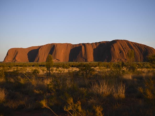 Uluru, also known as Ayers Rock is seen during sunrise at Uluru-Kata Tjuta National Park in the Northern Territory, Saturday, October 26, 2019. (AAP Image/Lukas Coch) NO ARCHIVING