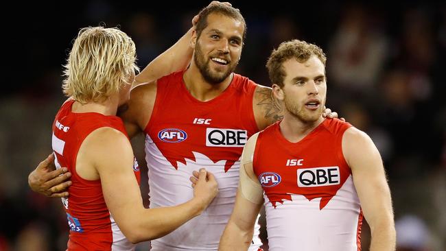 Isaac Heeney, Lance Franklin and Tom Mitchell celebrate a Sydney goal.