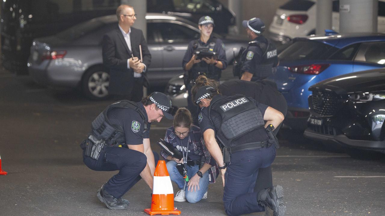 Police examine a bullet casing found after the shooting. Picture: Brett Hartwig