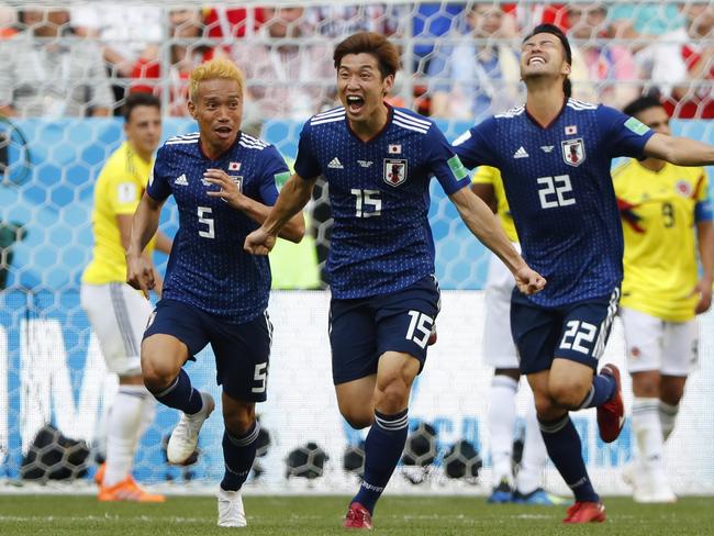 Japan's forward Yuya Osako (C) celebrates with teammates after scoring a goal. Pic: AFP