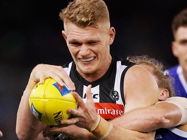 MELBOURNE, AUSTRALIA - JUNE 29: Adam Treloar of the Magpies gets tackled during the Round 15 AFL match between Collingwood v North Melbourne at Marvel Stadium on June 29, 2019 in Melbourne, Australia. (Photo by Michael Dodge/Getty Images)