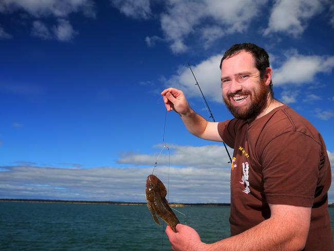 Dane Hansson (correct), 29 of West Moonah catching a couple of flathead to cook up for dinner tonight off McGee's Bridge at Midway Point.