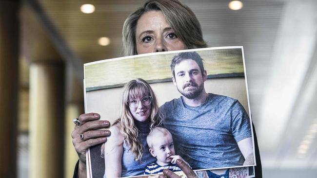 Opposition home affairs spokeswoman Kristina Keneally holds a photo of stranded Australians overseas, Andrew and Claire Burles with one-year-old Chester. Picture: NCA NewsWire/Gary Ramage