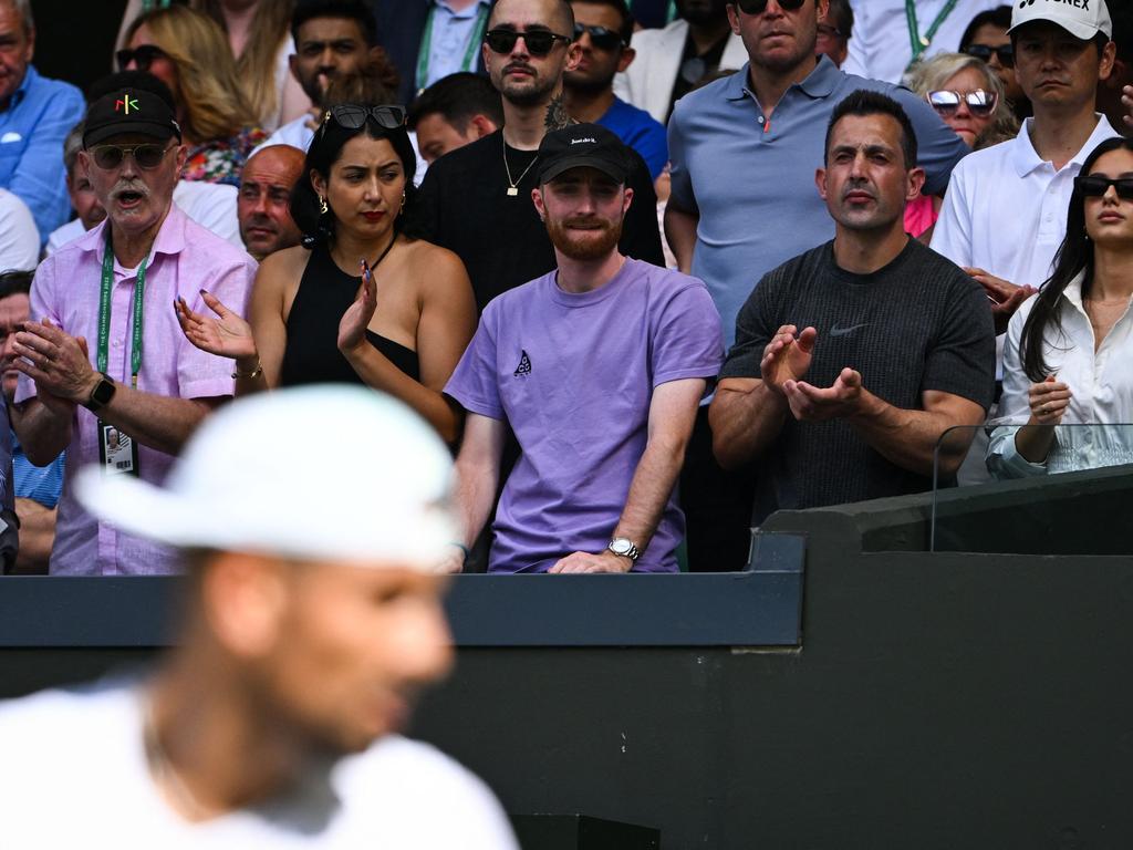 Australia's Nick Kyrgios' father, Matt Reid (L), his son's partner, Costeen Hatzi (R) and other team members cheer the Australian player during his men's singles final tennis match. Picture: AFP