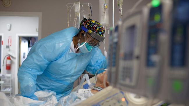 A healthcare worker comforts a patient in the Covid-19 ward at United Memorial Medical Center in Houston, Texas. Picture: AFP.