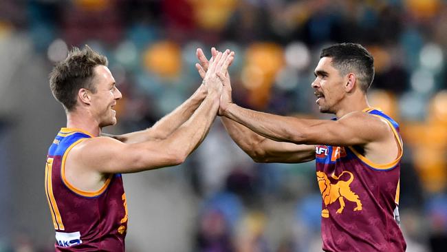 Charlie Cameron, right, celebrates one of his six goals with Lincoln McCarthy (left) against the Suns at the Gabba on Saturday. Picture: AAP Image/Darren England