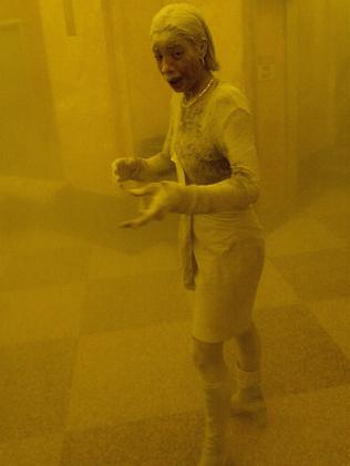 Marcy Borders, covered in dust, takes refuge in an office building. Picture: Stan Honda