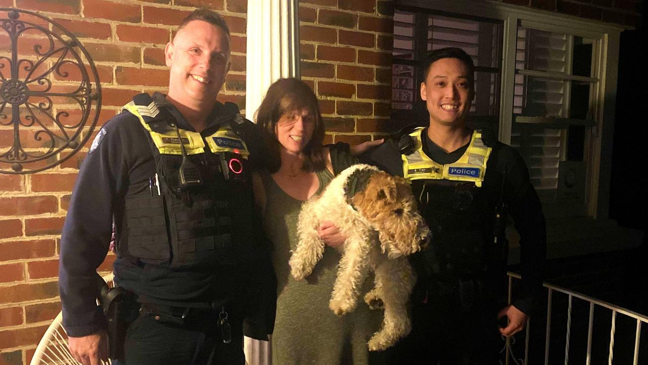 Fox Terrier Kyron was returned by Sergeant T. Fletcher and Constable A. Tran to his owner early on Christmas morning. Picture: Victoria Police.