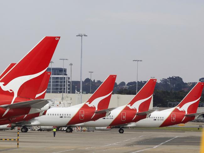 The tails of Qantas planes are lined up at Sydney Airport in Sydney, Sunday, Oct. 30, 2011. Qantas Airways grounded all of its aircraft around the world indefinitely Saturday due to ongoing strikes by its workers. (AP Photo/Rick Rycroft)