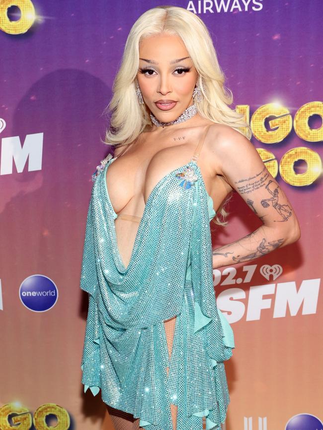 The rapper rocked a striking aqua mini-dress to the annual day concert. Picture: Phillip Faraone/Getty Images for iHeartRadio