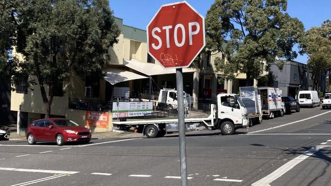 Cars and trucks travel into the intersection from connecting roads including the Pacific Hwy.