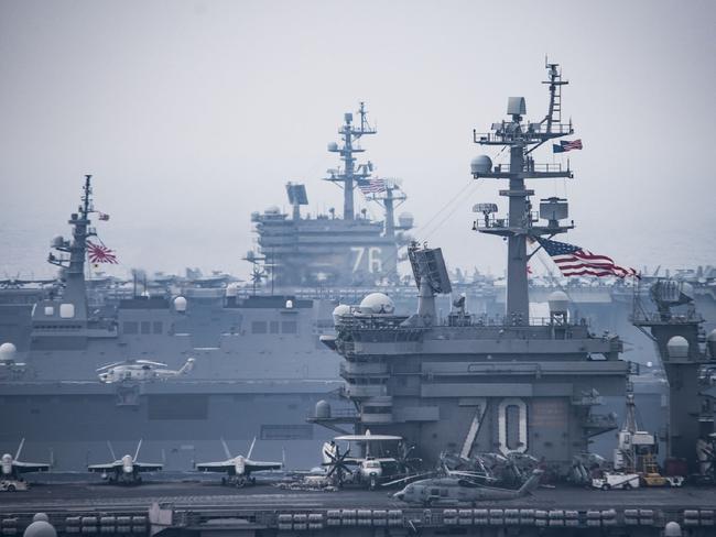 This US Navy handout photo shows the Carl Vinson Carrier Strike Group with Japan Maritime Self-Defense Force ships in the western Pacific region on June 1, 2017. The Japan Maritime Self-Defense Force and US Navy forces routinely train together to improve interoperability and readiness. Picture: US Navy Office of Information