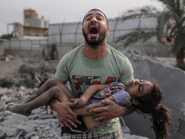 A Palestinian man holds the body of his cousin that he pulled from the rubble after Israeli air strikes in Gaza City. Picture: Belal Khaled/Anadolu Agency via Getty Images