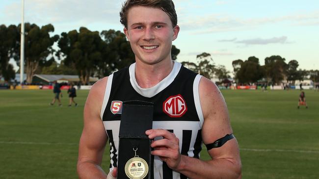 Port Adelaide’s Xavier Duursma proudly shows off the medal he won as best afield in the Russell Ebert tribute match. Picture: Peter Argent.