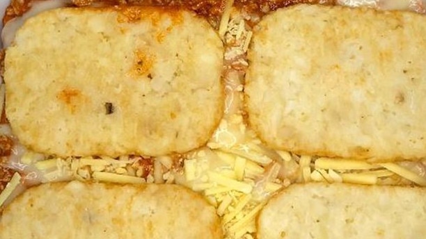 Lay out some hash browns in a lasagne dish.