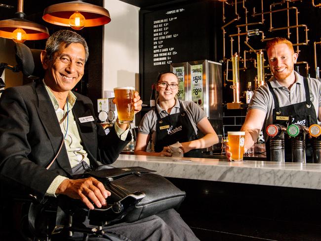 Pub goer Charles Savage and Coopers Alehouse Gepps Cross employees Brooke Thomas and Jason Goodwin celebrating the easing of restrictions for pubs, clubs and restaurants which will now be able to host 75 per cent of their capacity in Adelaide, March 24, 2021. (The Advertiser/ Morgan Sette)