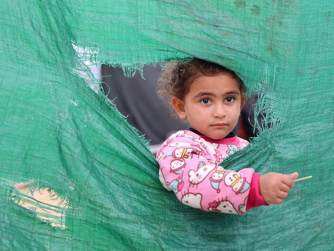 A Palestinian girl stands outside her tent at a makeshift camp for displaced Palestinians, during a storm in Gaza City on December 31, 2024. Picture: AFP