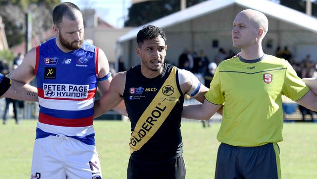 14/8/21 - SANFL game between Glenelg and Central District at Glenelg Oval. Marlon Motlop speaks to players in a huddle before the start of the game. Picture: Naomi Jellicoe