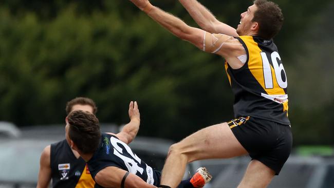 Woori Yallock’s Michael Batten takes flight. Picture: Stuart Milligan