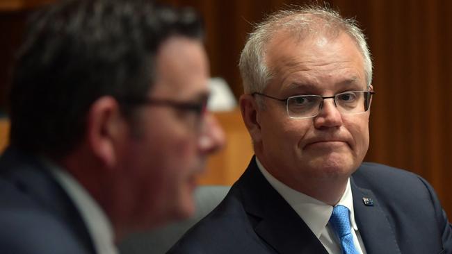 Prime Minister Scott Morrison (right) watches on as Victorian Premier Daniel Andrews speaks to media following a national cabinet meeting earlier this month. Picture: Getty Images