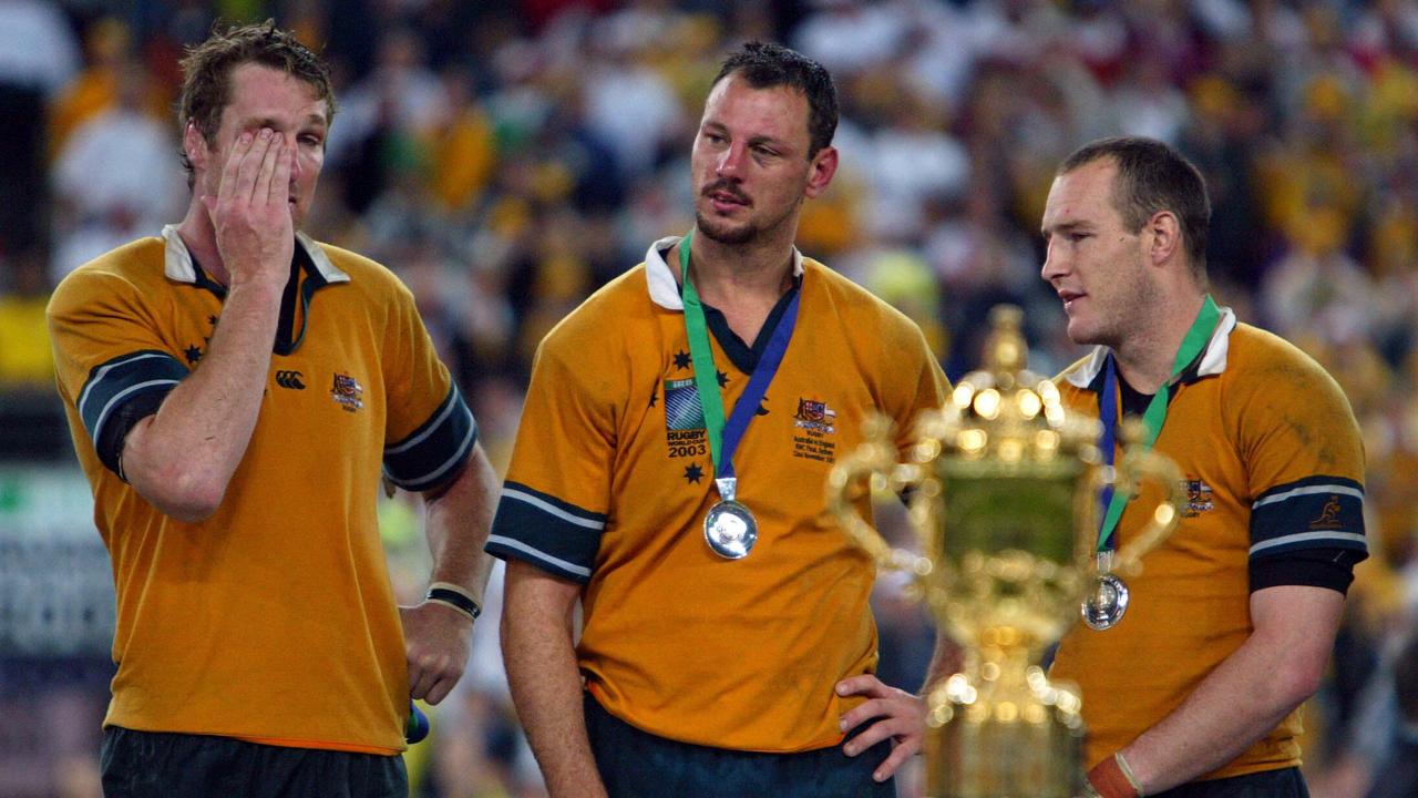 NOVEMBER 22, 2003 : Wallabies players (L-R) Justin Harrison, Matt Cockbain &amp; Stirling Mortlock with their losers medals on podium during presentation ceremony after England defeated Australia in 2003 World Cup (RWC) final at Telstra Stadium in Sydney, 22/11/03. Pic Gregg Porteous. Rugby Union