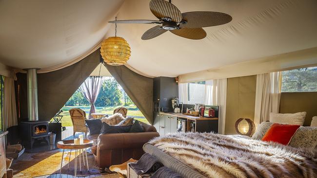 Kanimbia Glamping's decadent tents are loaded with luxuries, including a fireplace and beautiful bed.