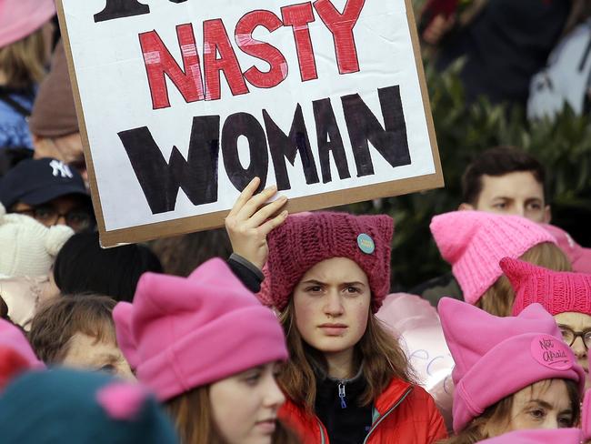 A woman holds a sign amidst a sea of pink caps before a women's march Saturday, Jan. 21, 2017, in Seattle. Women across the Pacific Northwest marched in solidarity with the Women's March on Washington and to send a message in support of women's rights and other causes. (AP Photo/Elaine Thompson)