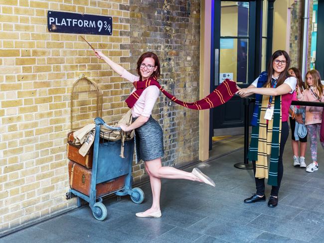 London UK - June 16 2016: Platform 9 three-quarter at Kings Cross Station with unidentified people. The platform is a fictive one from Harry Potter movies installed at Kings Cross for tourists