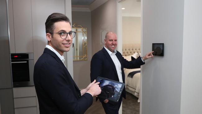 Lateral Estate CEO Tony Johnson (R) and interior designer Luke Davidson show off the tech inside a display home in Kogarah, Sydney. Picture: Brett Costello