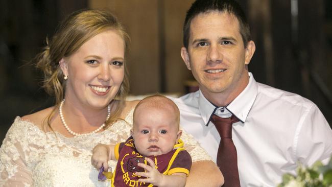 Happy day: Dion Ward &amp; Ashleigh Thiele dressed baby Hannah Chloe in a Broncos kit for the celebration, pic: Ben Clark Photography