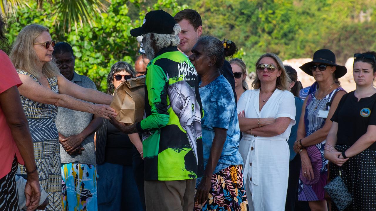 NT Coroner Elisabeth Armitage hands the belongings of Ngeygo Ragurrk to her father Tommy Madjalgaidj at a ceremony at Mindil Beach, where on December 23 2019 the 40-year-old was killed by her partner Garsek Nawirridj. Picture: Pema Tamang Pakhrin