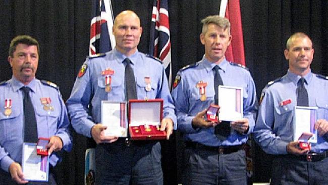 Bill Edgar and his colleagues Firefighter Brad Izod, Senior Firefighter Tony Wildman, and Station Officer Matt Phillips receiving the QFRS Commissioner’s Medal of Valour for a fearless rescue mission in Widgee Creek during the January 2013 floods.