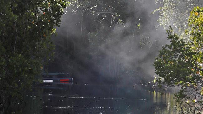 Warning signs and a croc trap at Deep Creek at Kewarra Beach.