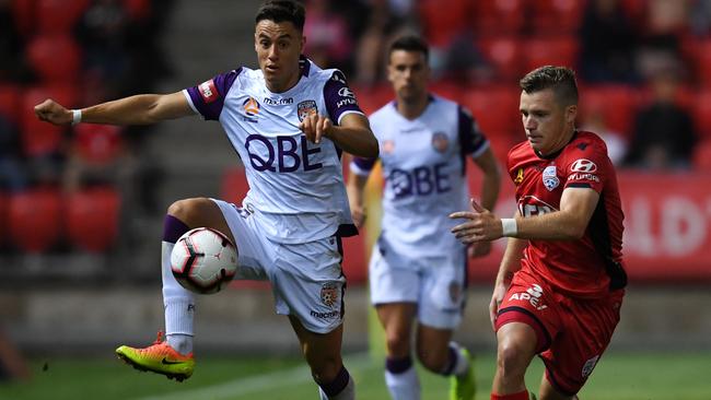 Chris Ikonomidis of Perth Glory competes with Scott Galloway of Adelaide United on Friday night. Picture: Mark Brake/Getty Images