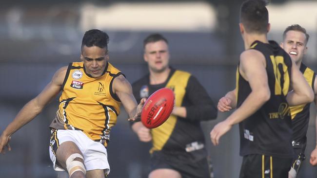 Mawson Lakes’ Norman Wombat clears the ball during the 2019 division grand final against St Paul’s Old Scholars. Picture: Dean Martin