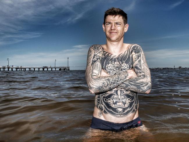 Recovery: Nick Hall gets out the aches and pains with a dip in Port Phillip Bay. Picture: Colleen Petch