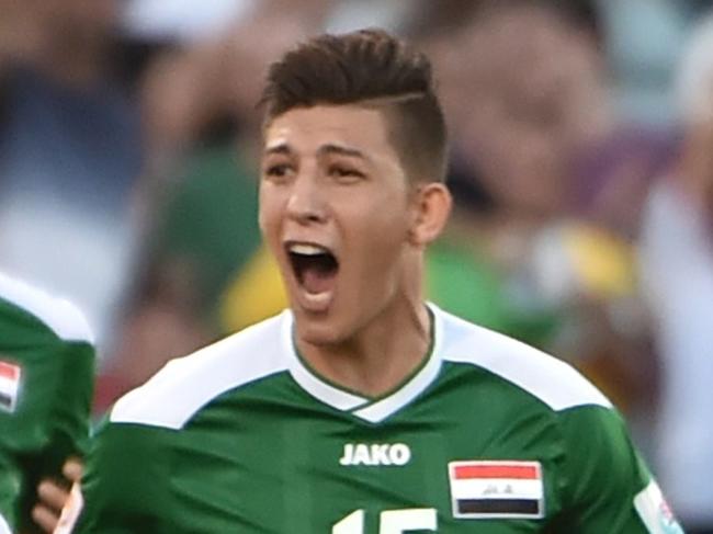 Dhurgham Ismael of Iraq (R) celebrates scoring a penalty goal in extra time against Iran during their AFC Asian Cup quarter-final football match in Canberra on January 23, 2015. AFP PHOTO/Peter PARKS --IMAGE RESTRICTED TO EDITORIAL USE - STRICTLY NO COMMERCIAL USE
