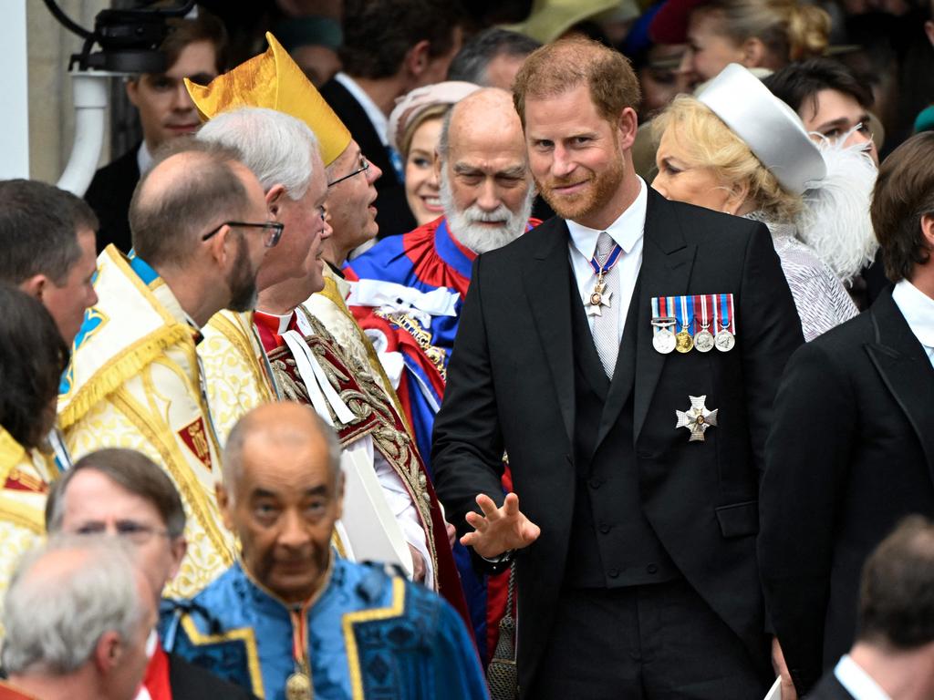 The Duke of Sussex makes a run for it after the ceremony. Picture: AFP