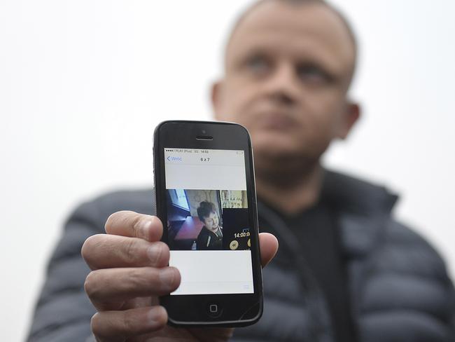 Ariel Zurawski, the owner of a Polish trucking company, shows the last photo taken of his cousin and driver, Lukasz Urban. Picture: AP Photo