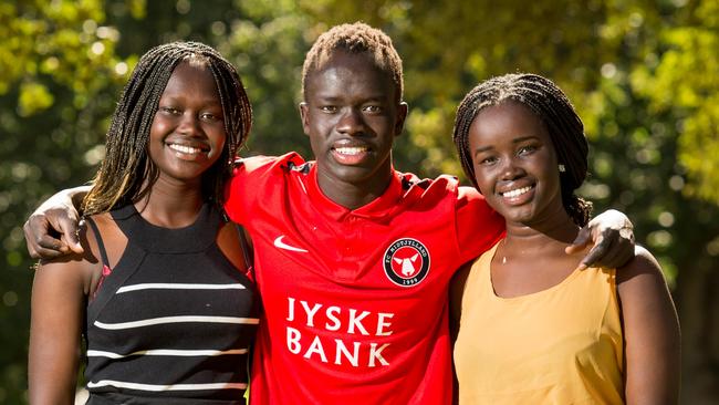 Bor Mabil, right, pictured with brother Awer and cousin Abiei Ajak, died in a 2019 car crash. Picture: James Elsby.