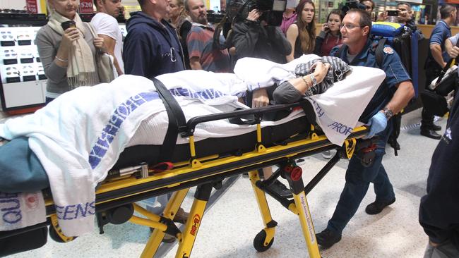 Kathy Devitt is taken to hospital after the shooting at Robina Town Centre in 2012.